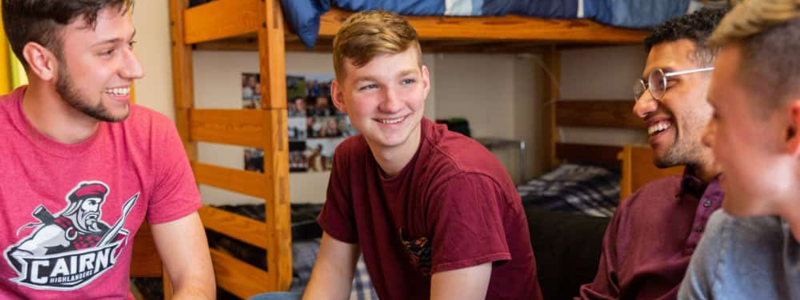 smiling Cairn students in a dorm